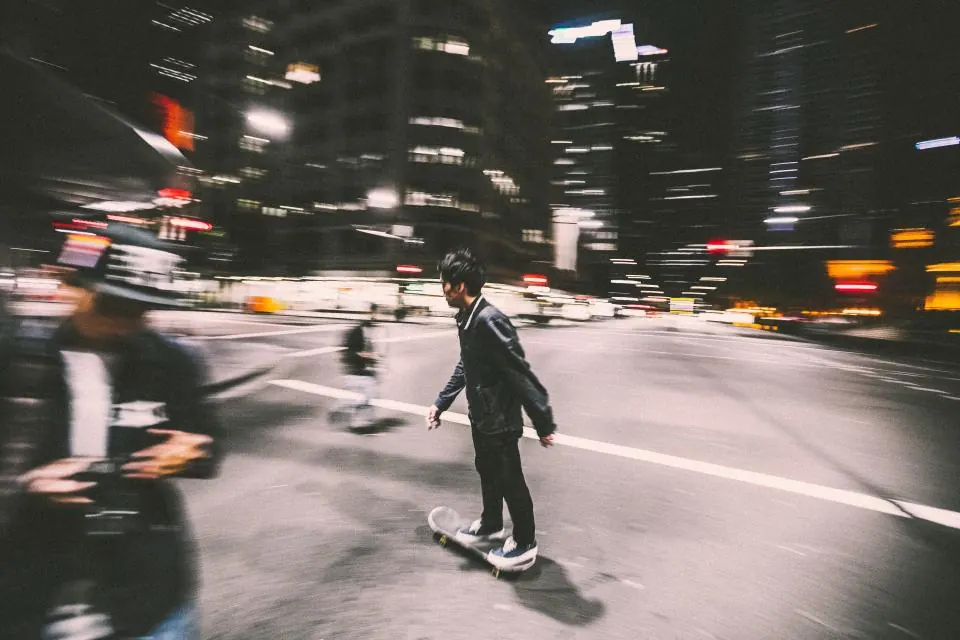 Skateboarder rolling through a city street